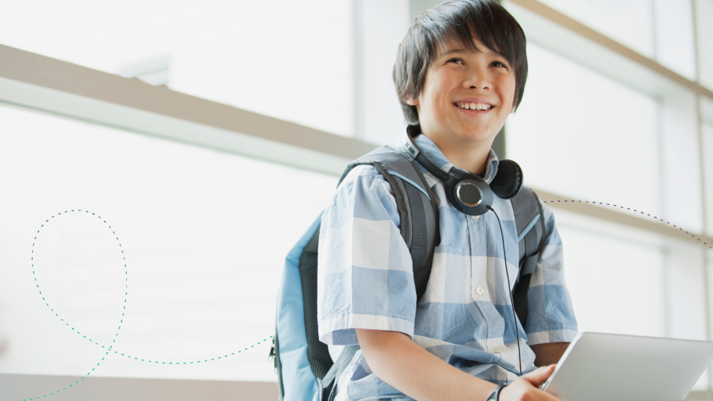 Middle school aged boy wearing a stripped polo and smiling.